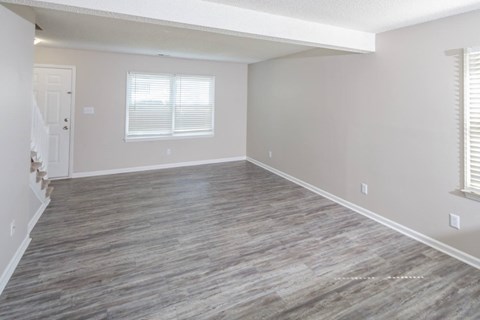 An empty living room with windows