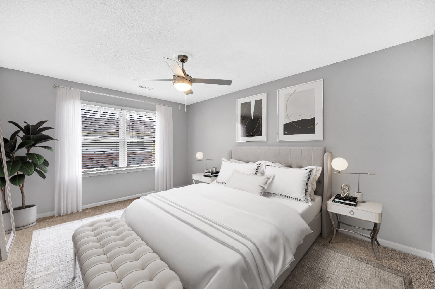 a white bedroom with a large bed and a ceiling fan