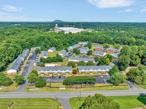 an aerial view of a apartment complex of buildings and trees