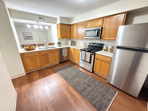 A kitchen with wooden cabinets and stainless steel appliances.