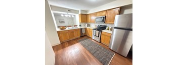 A kitchen with wooden cabinets and stainless steel appliances.