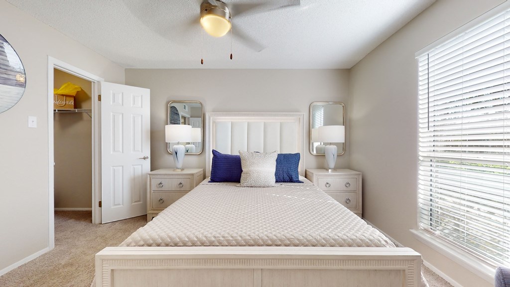 a bedroom with a bed and two night stands with lamps at Breckinridge Vue, Georgia