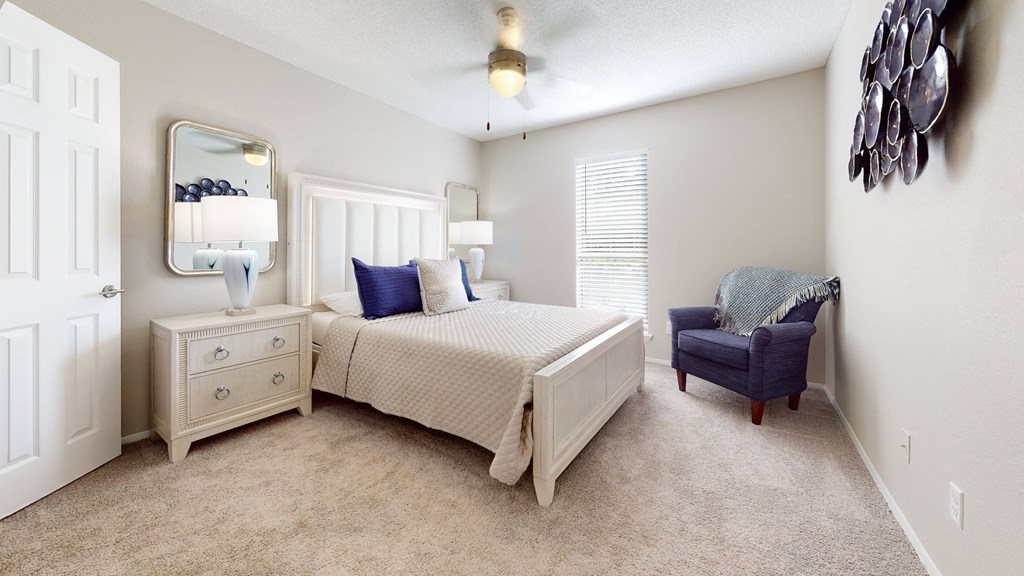 a bedroom with a bed and a chair at Breckinridge Vue, Duluth, Georgia