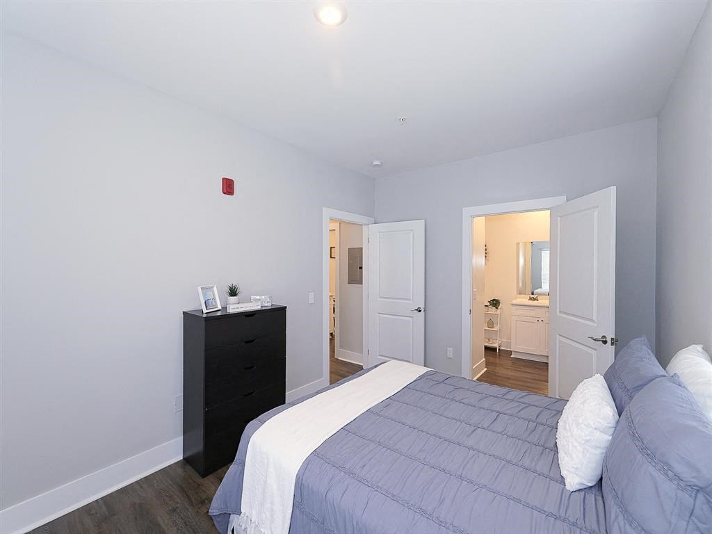 a bedroom with a bed and a door to a bathroom