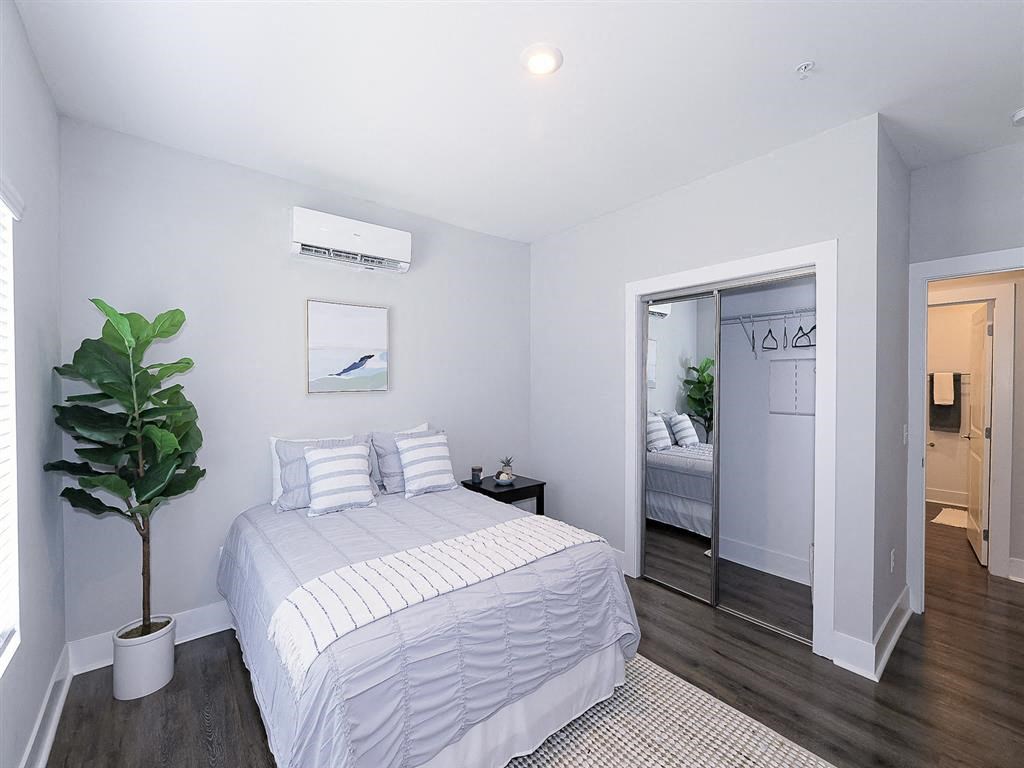 a bedroom with a bed and a door to a bathroom