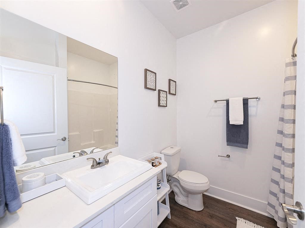 a bathroom with a sink toilet and a mirror