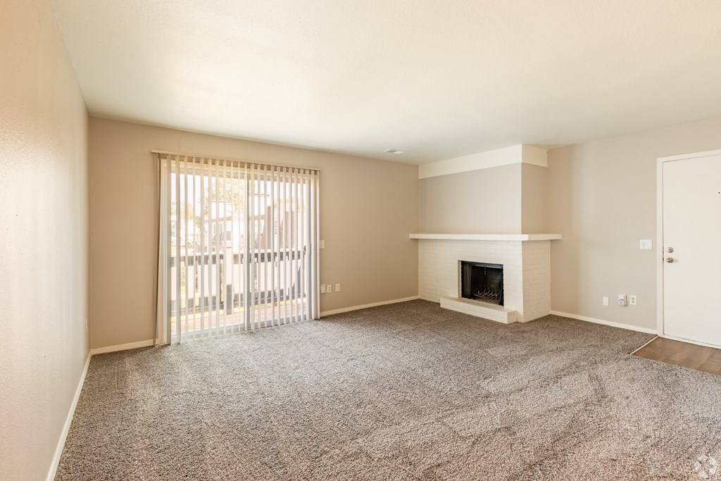 a living room with a fireplace and a sliding glass door