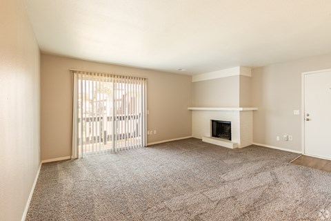 a living room with a fireplace and a sliding glass door