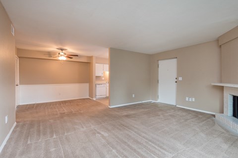 a living room with a fireplace and a ceiling fan