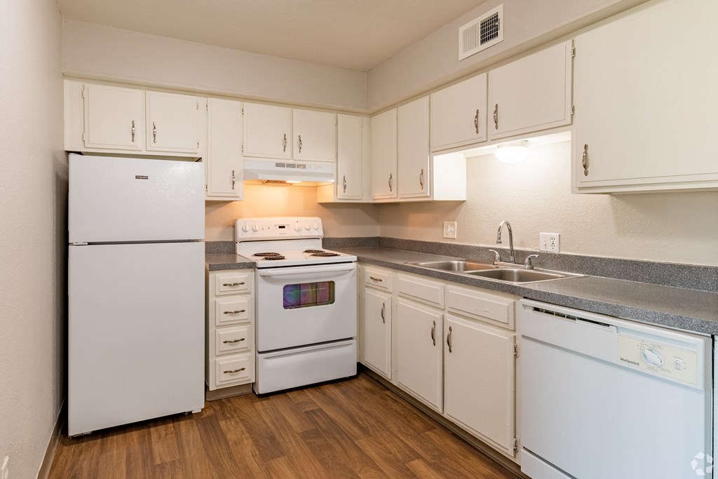 a kitchen with white appliances and white cabinets