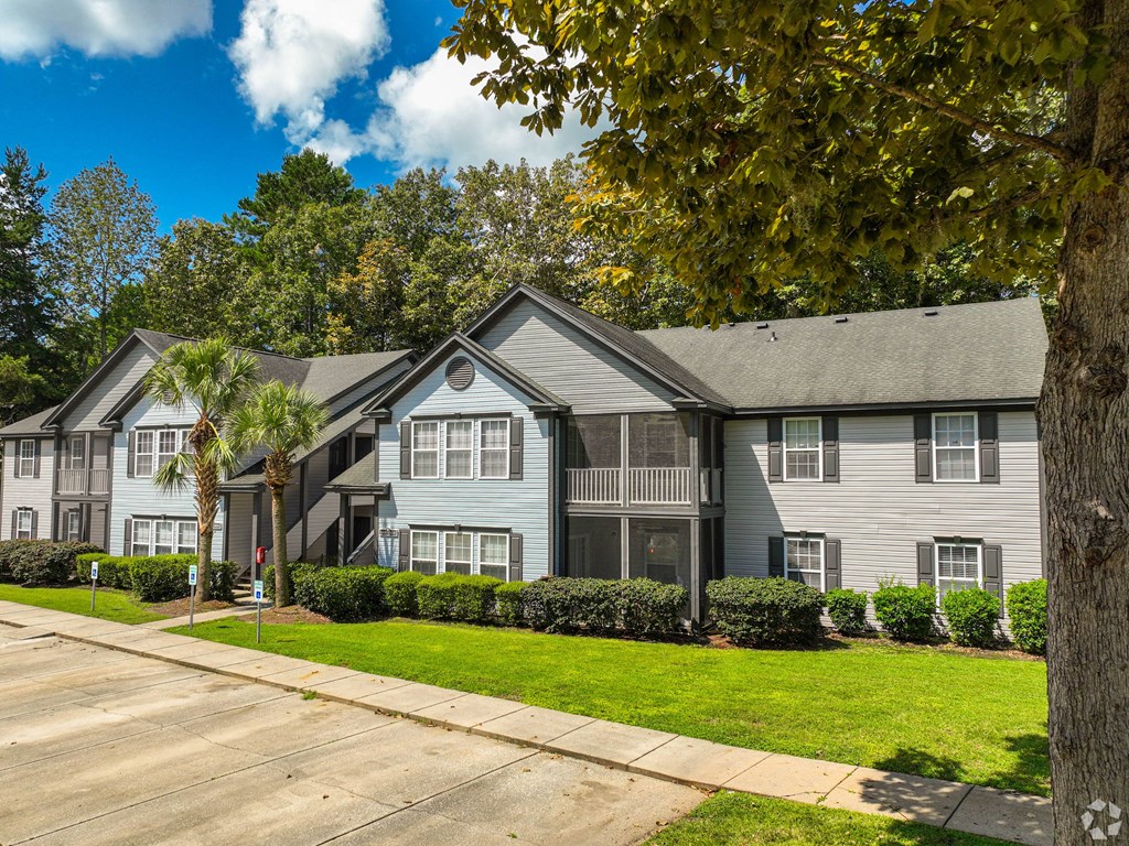 a gray house with a sidewalk in front of it