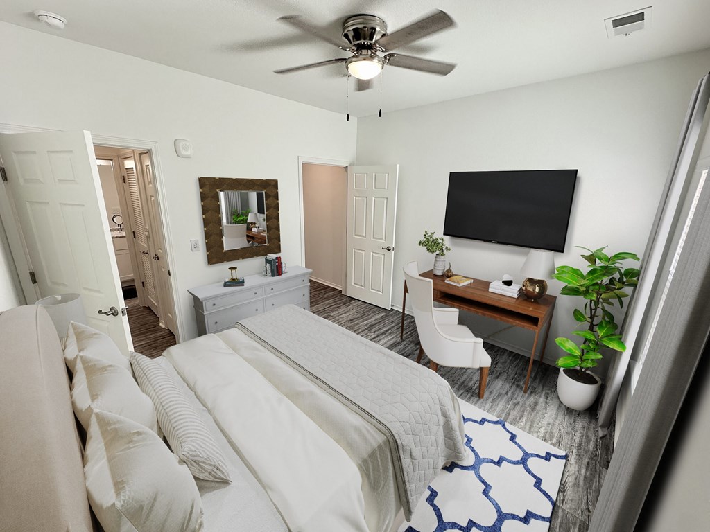 A bedroom with a large bed and a flat screen TV mounted on the wall.