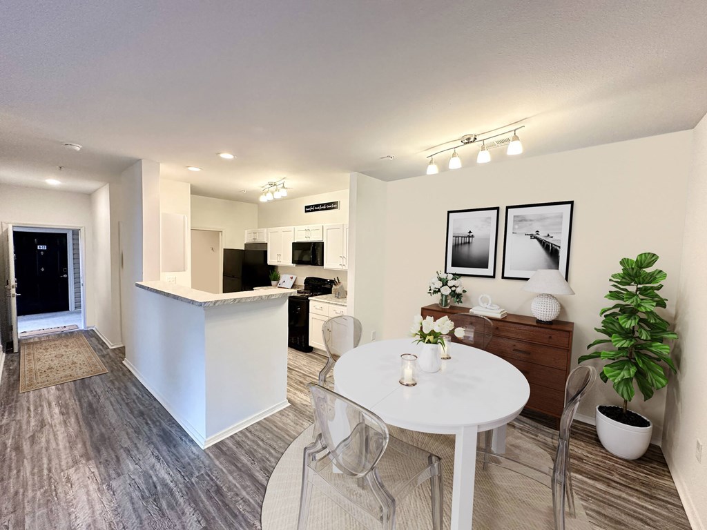 A modern kitchen with a dining table and chairs.