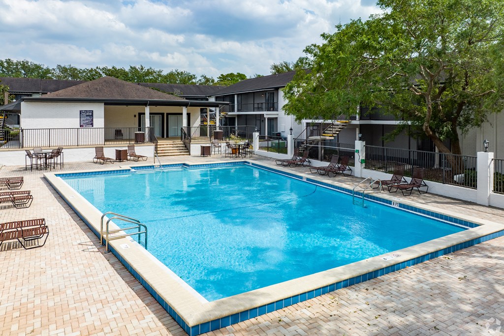 a swimming pool at a hotel with a blue pool at The Essex, Altamonte Springs