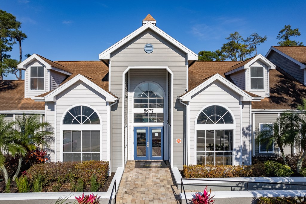 the exterior of a home with white siding and a brown roof at The Adelaide, Orlando, FL, 32821
