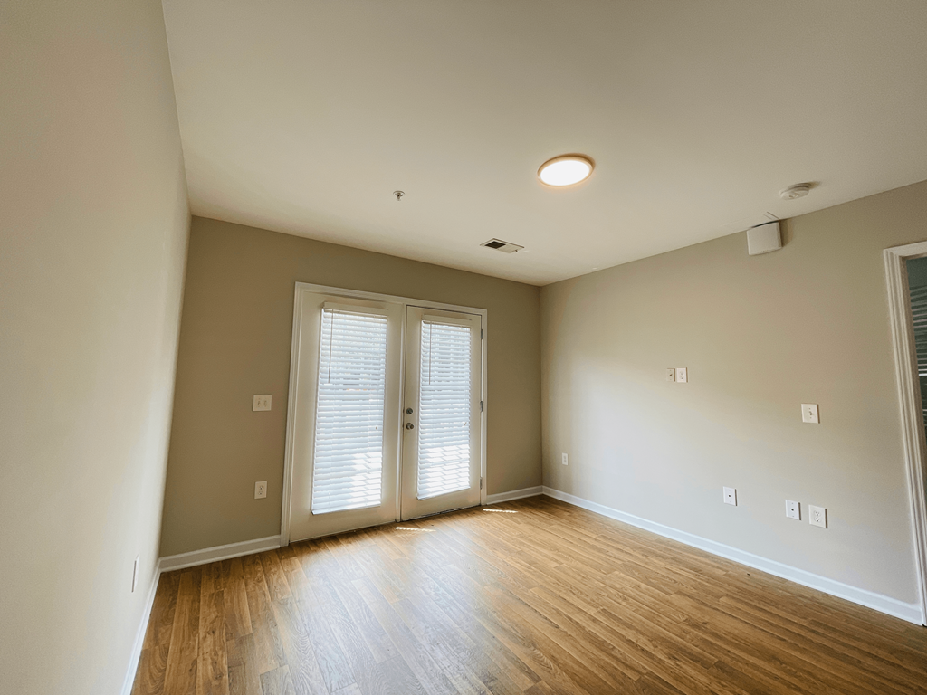 Living room with practical hardwood flooring at Oasis at Cedar Branch in Wilmington, NC