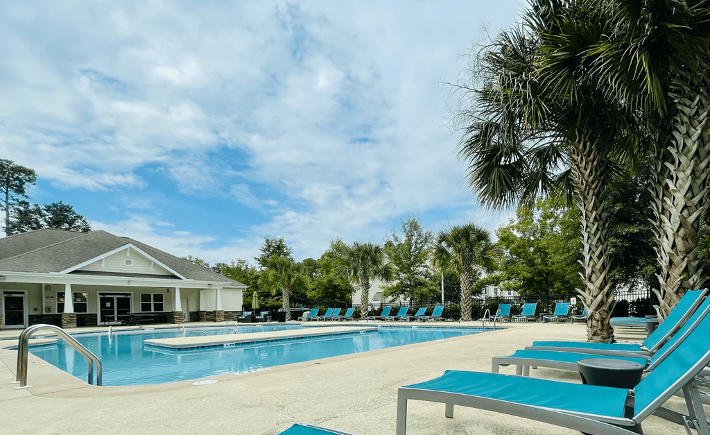 Beautiful pool with loungers Beautiful pool with loungers at Oasis at Cedar Branch in Wilmington, NC