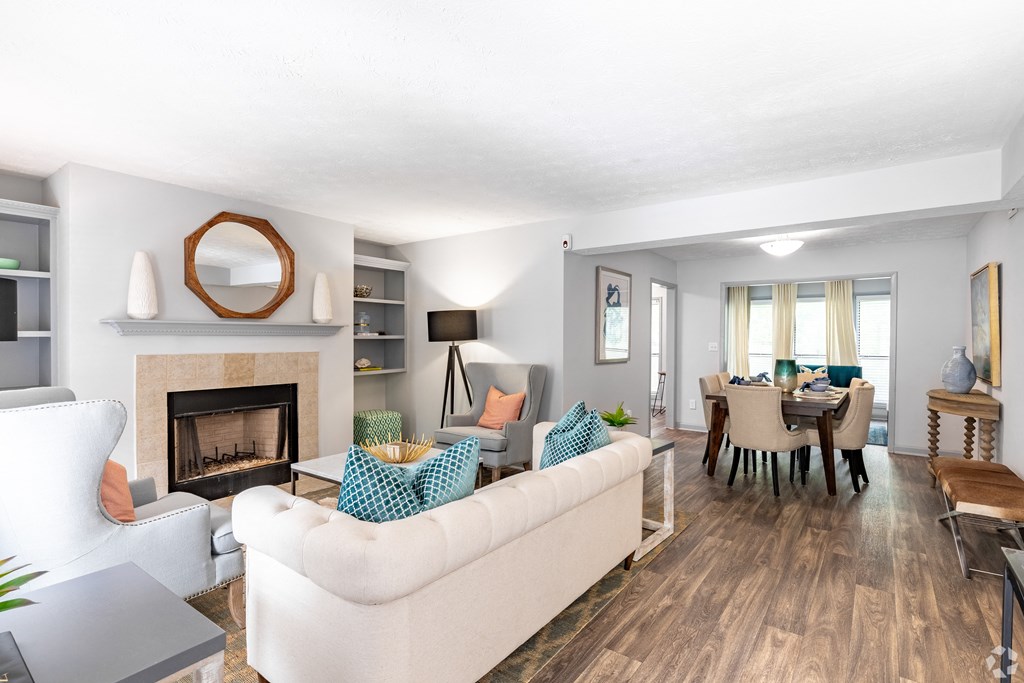 the living room and dining room of a house with a fireplace