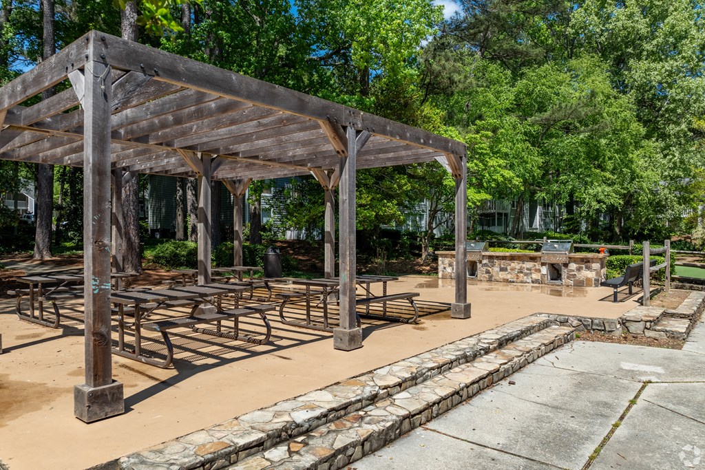 a group of picnic tables under a pavilion in a park