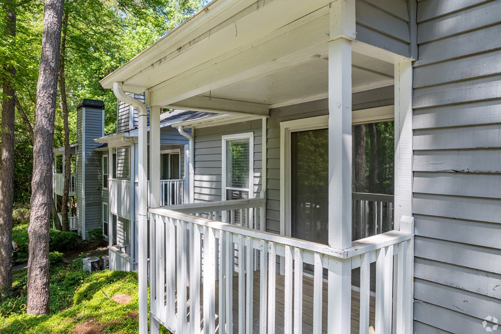 the front porch of a house with a white railing