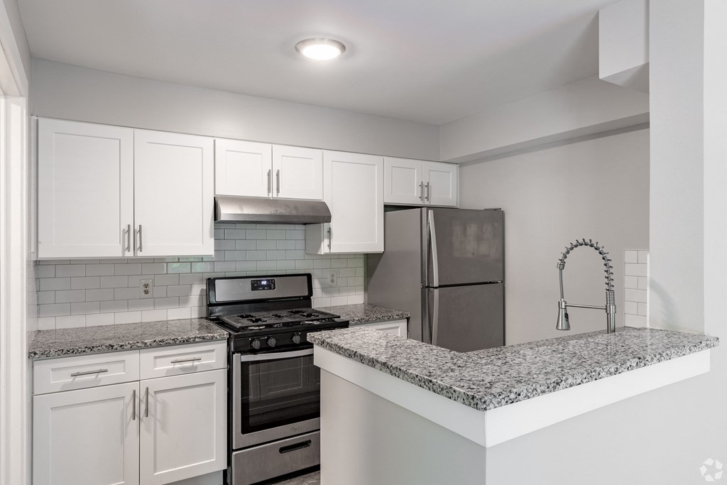a kitchen with granite counter tops and stainless steel appliances
