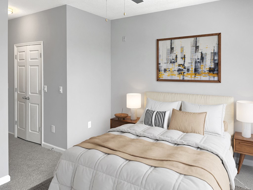 a bedroom with a large bed and a painting on the wall