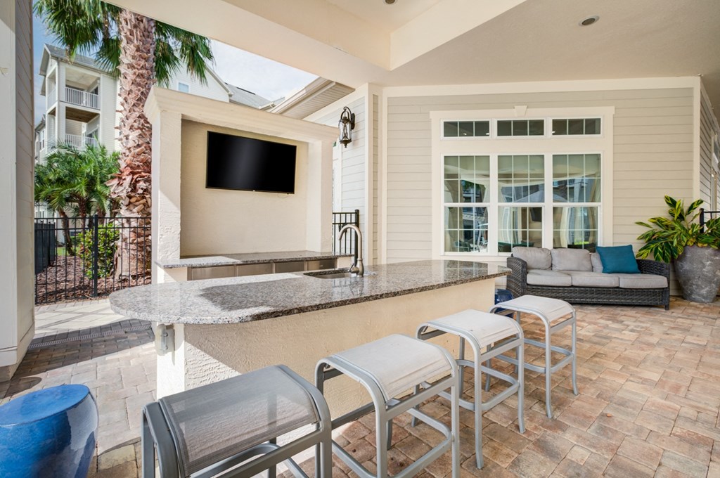 a patio with a bar and a couch  at Century Avenues, Lakeland, FL, 33813
