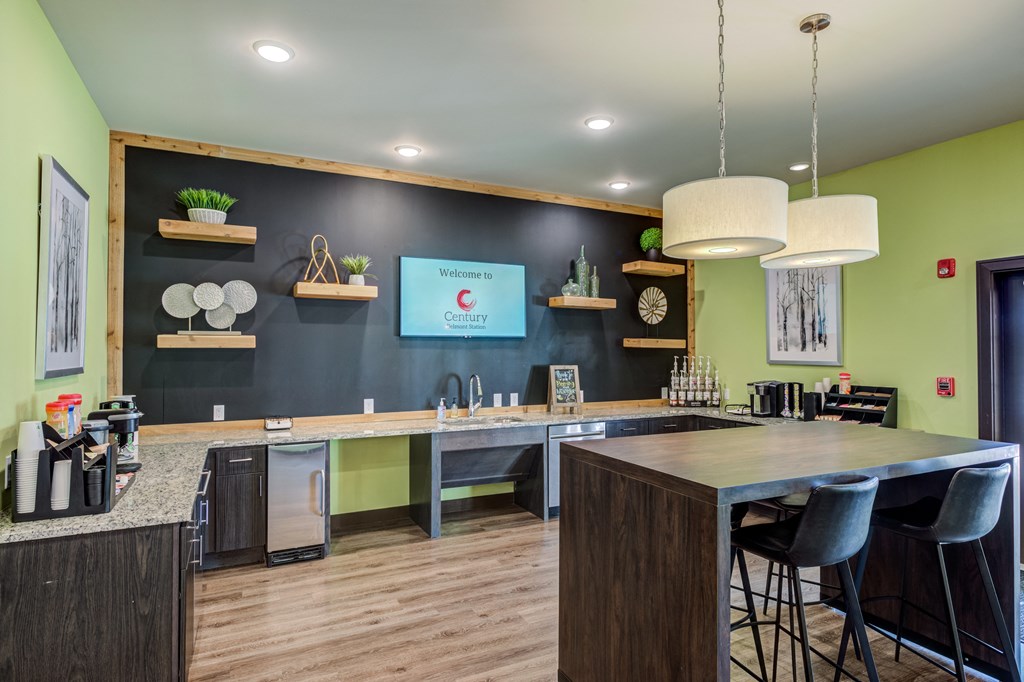 a kitchen with a large island with a breakfast bar and a tv on the wall at Century Belmont Station, Louisville, KY