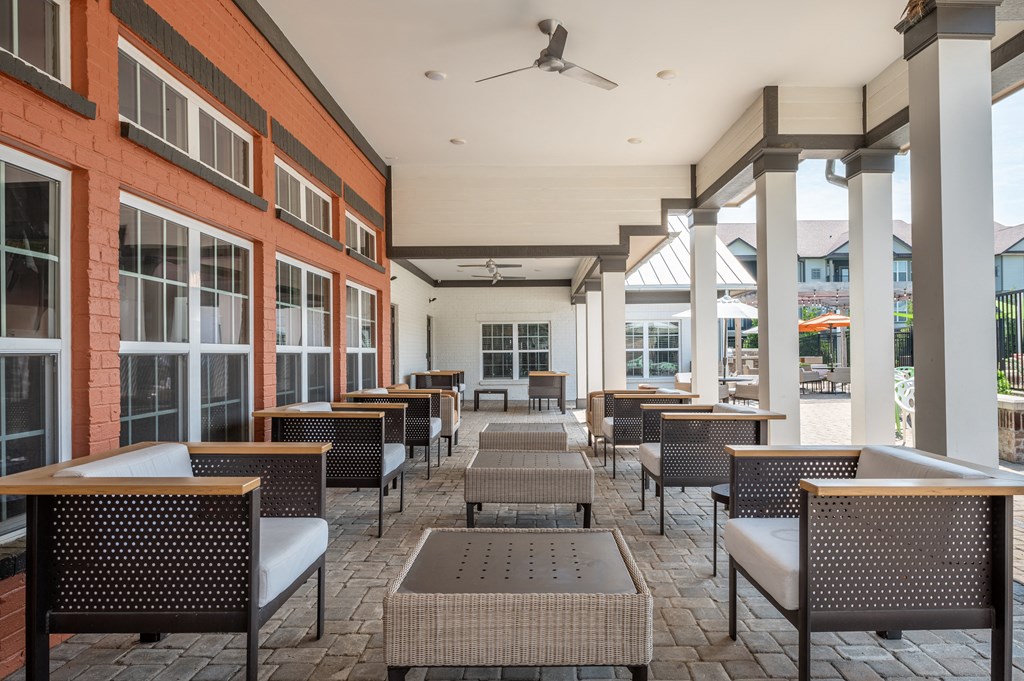 a covered patio with tables and chairs at Century Belmont Station, Louisville, Kentucky