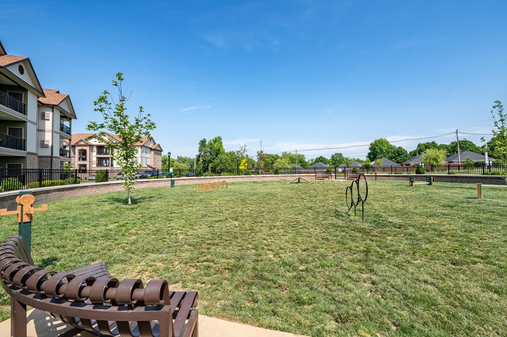 a large grassy area with a bench in front of it at Century Belmont Station, Louisville, KY