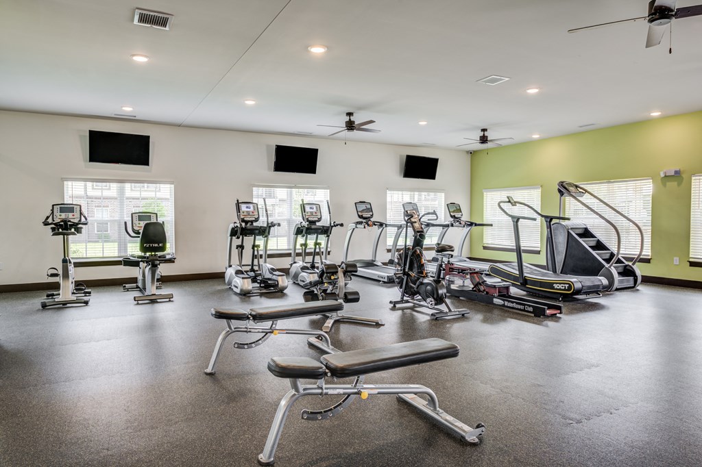 a gym with treadmills and other exercise equipment at Century Belmont Station, Louisville, 40243