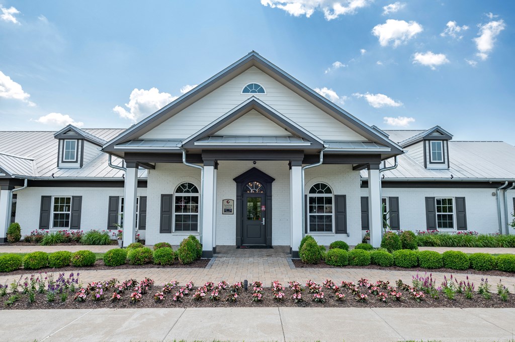 a large white building with a gray roof and white pillars at Century Belmont Station, Louisville
