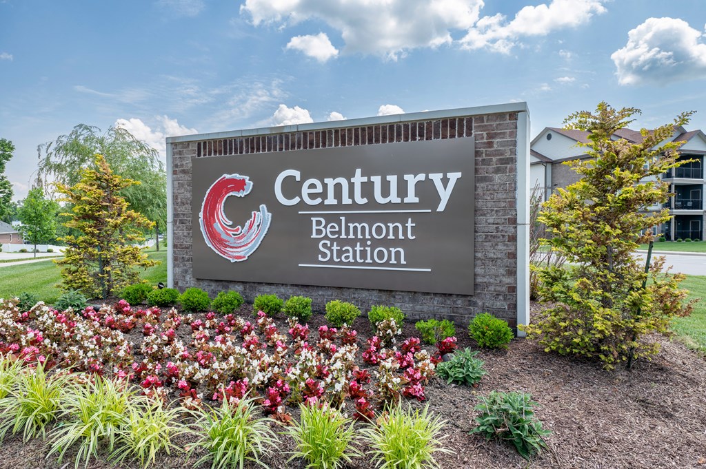 a sign for the belmont station with flowers in front of it at Century Belmont Station, Louisville, KY