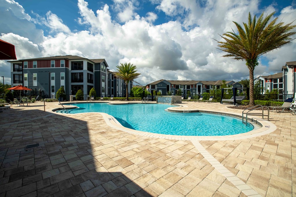 a large swimming pool in front of an apartment building at Century Dunes Apartments, Deland, Florida