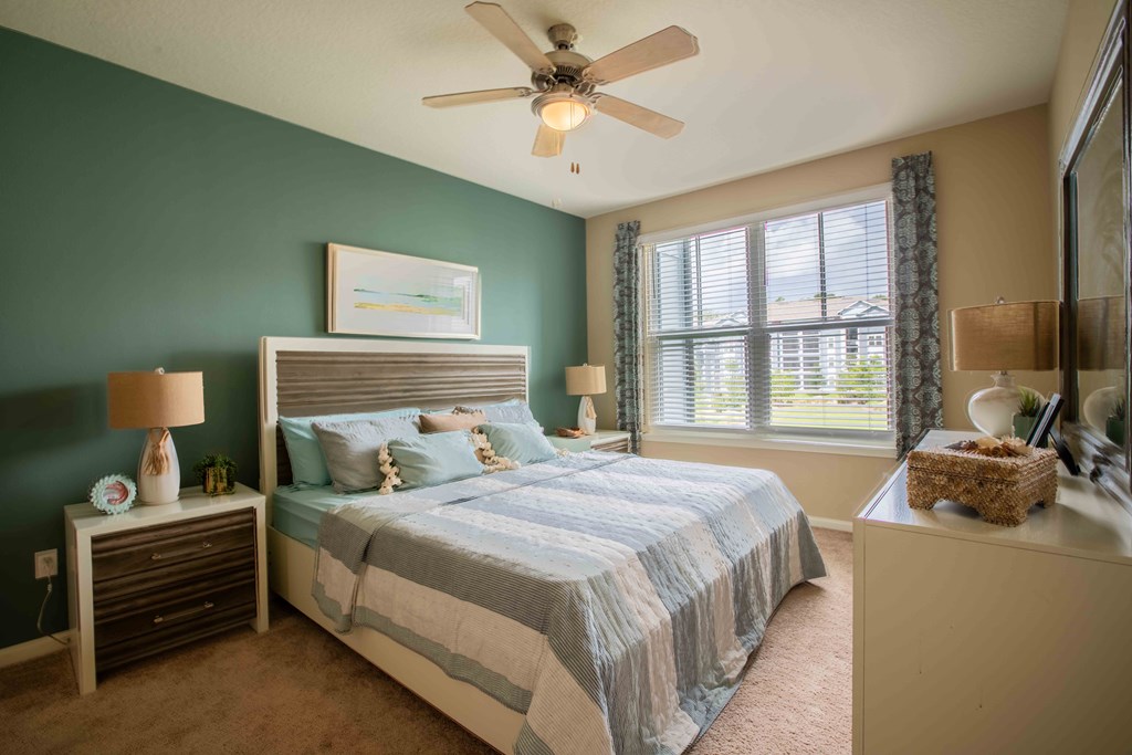 a bedroom with a bed and a ceiling fan at Century Dunes Apartments, Deland