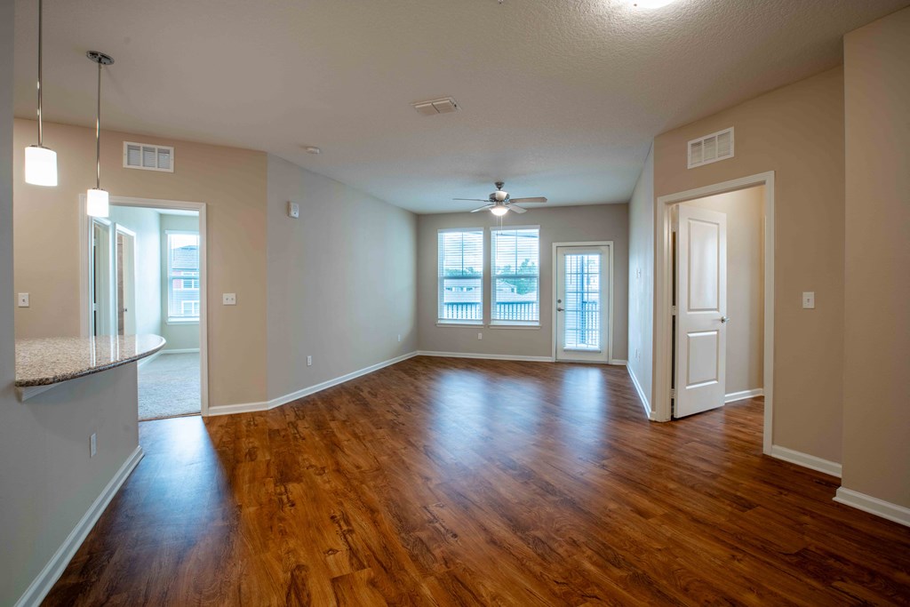an empty living room with a hard wood floor at Century Dunes Apartments, Deland, Florida