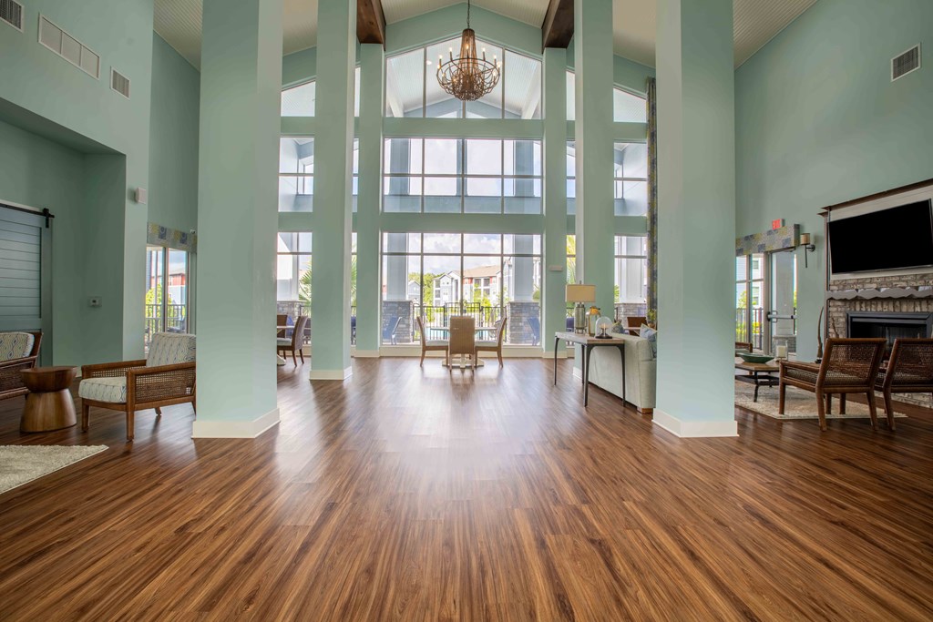 spacious living room with large windows and a wood floor at Century Dunes Apartments, Deland