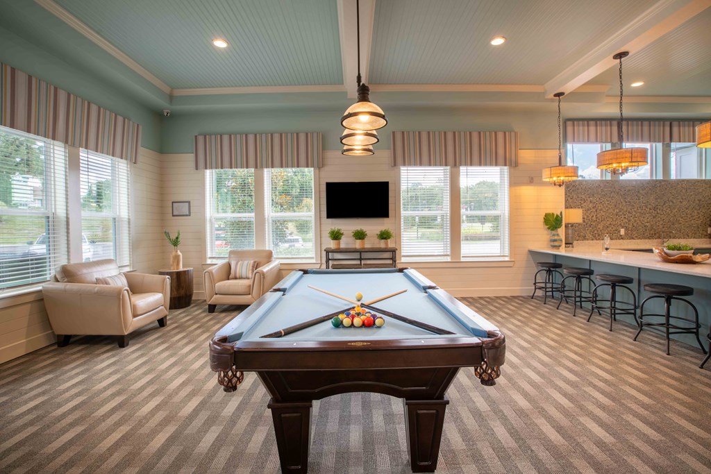 a game room with a pool table and a bar at Century Dunes Apartments, Florida