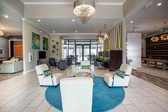 lobby with couches and chairs and a blue rug
