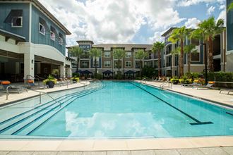 a large swimming pool with a building in the background