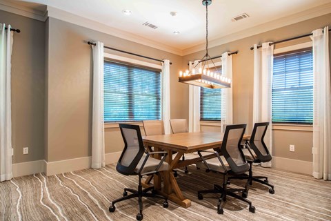 a dining room with a table and chairs and a chandelier at Century New Holland, Gainesville, Georgia