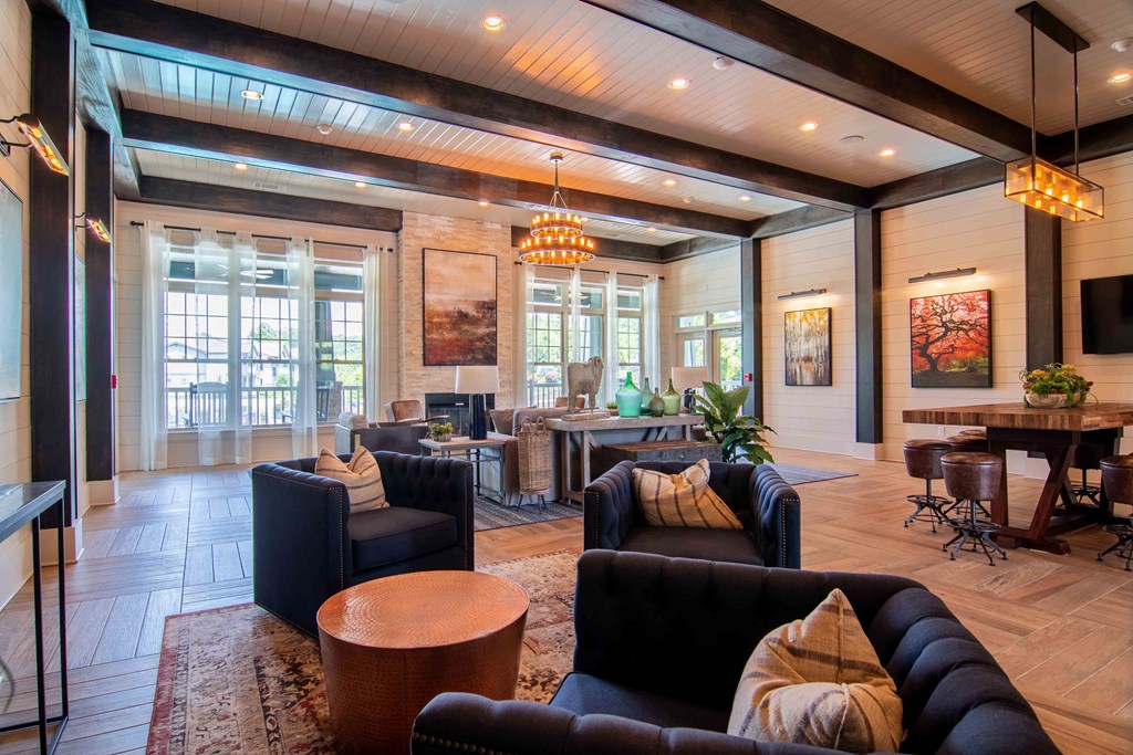 a living room with couches and chairs and a table at Century New Holland, Gainesville, GA, 30501