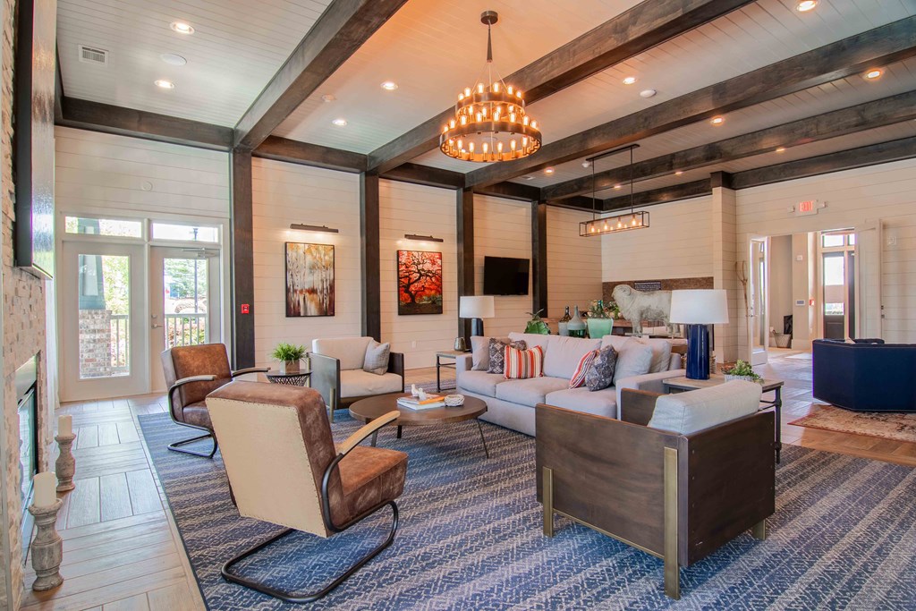 a living room with couches and chairs and a fireplace  at Century New Holland, Gainesville