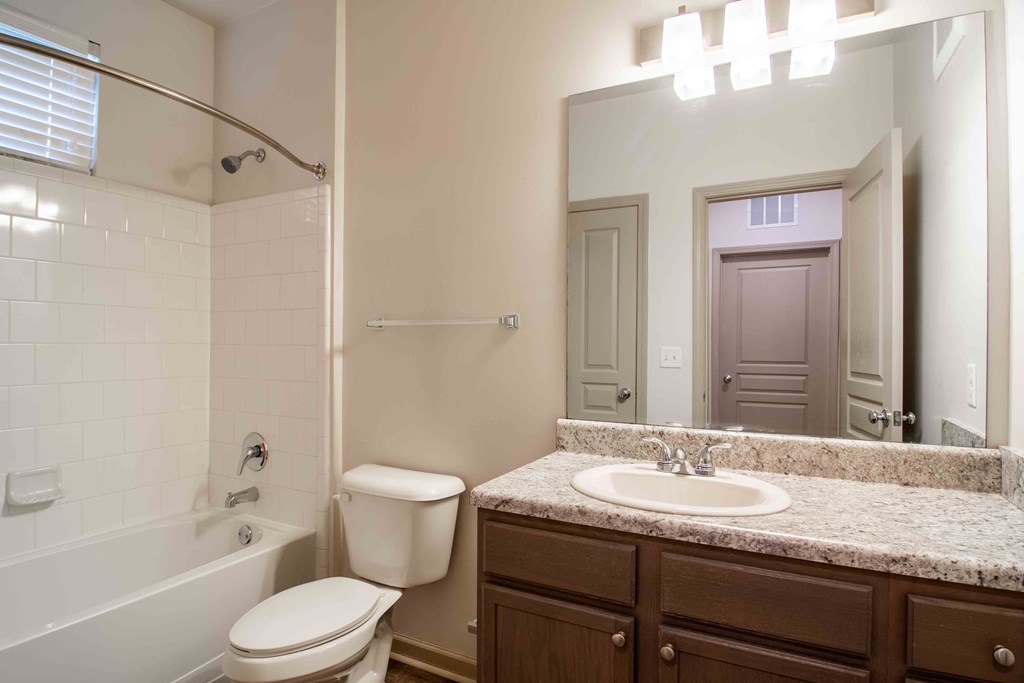 a bathroom with a sink and a toilet and a tub at Century New Holland, Gainesville, Georgia