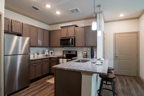a kitchen with stainless steel appliances and granite counter tops