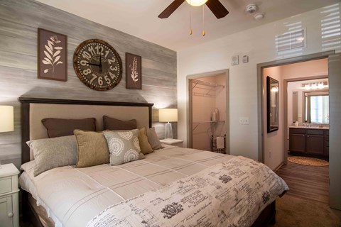 a bedroom with a large bed and a clock on the wall at Century New Holland, Georgia
