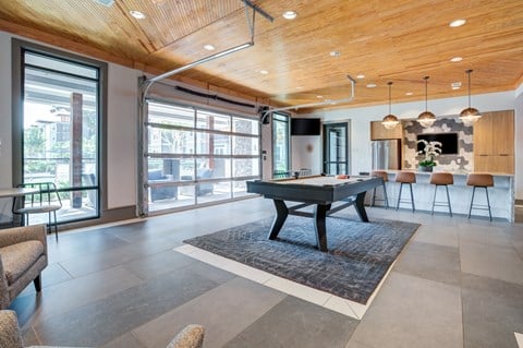 a game room with a pool table in the middle of it at Century Town Center, Gainesville, 32607