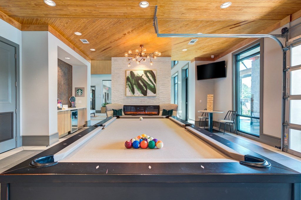 a pool table with balls on it in a large room with a fireplace at Century Town Center, Florida