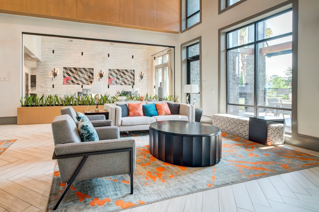 a living room with couches and chairs and a coffee table at Century Town Center, Florida