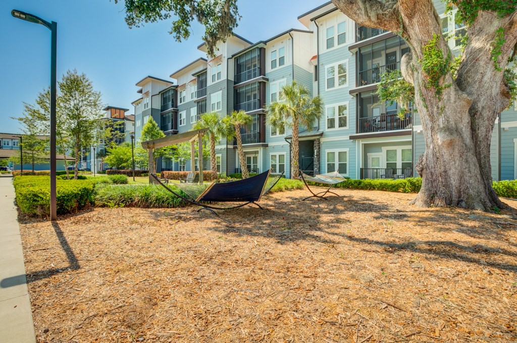 a hammock on the ground in front of an apartment building at Century Town Center, Gainesville